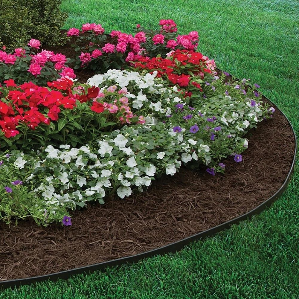 Black garden edging following a curved flower bed beside a green lawn